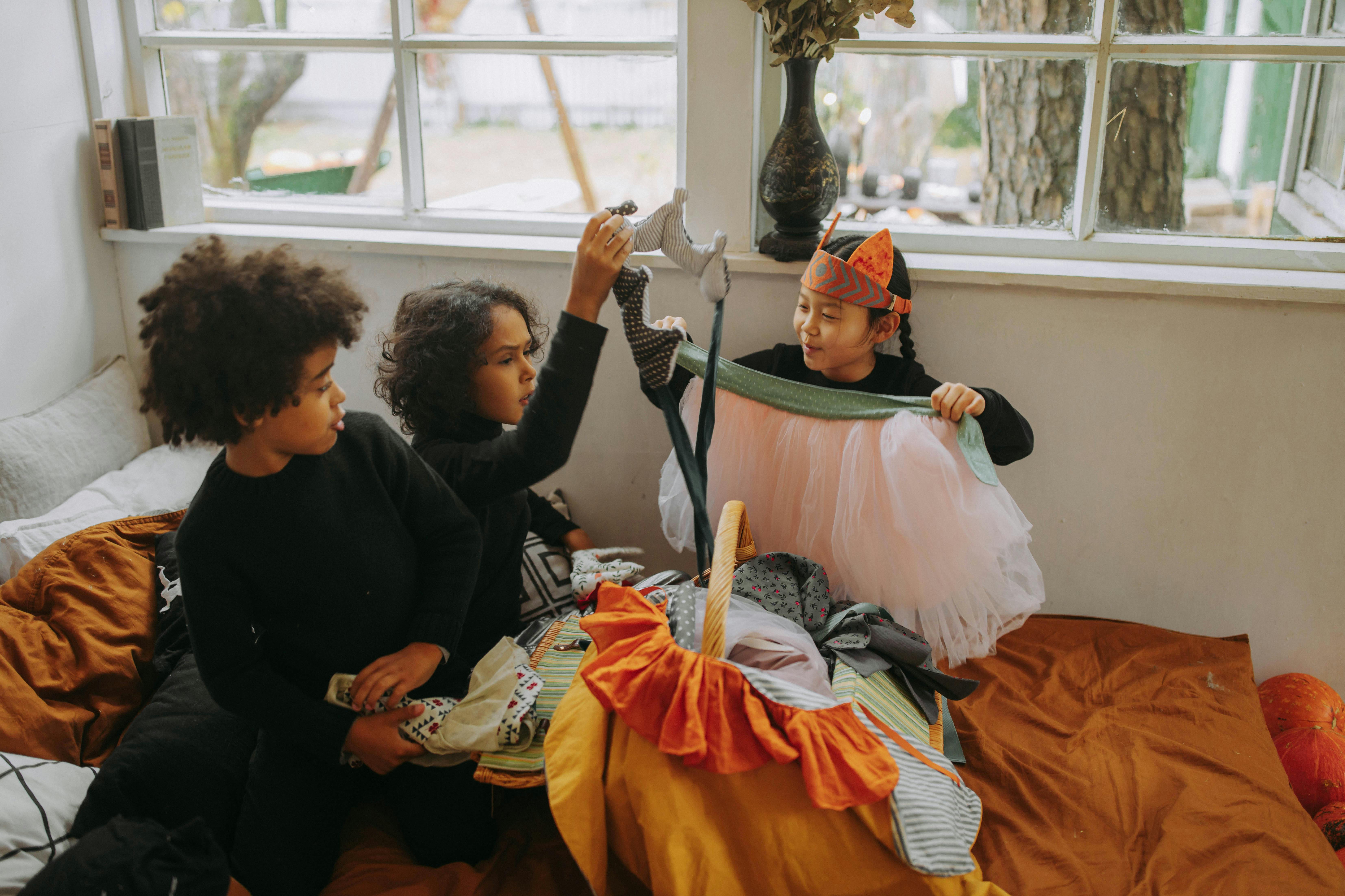 Children playing Halloween games indoors wearing fun costumes and accessories
